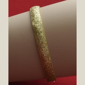 Nyt armbnd med guldglitter og charm. 5 indstillingshuller. Nypris 299kr.