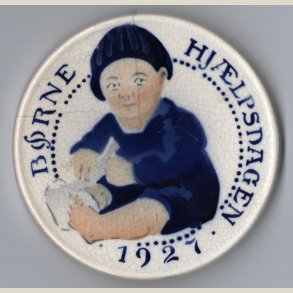 Brnehjlpsdagen 1927. Alumenia. 9cm. i diameter. Med en del skader.
